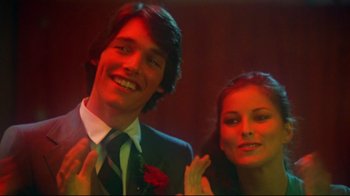 Movie still from “Prom Night” (1980), directed by Paul Lynch – A man and a woman posing for a picture; Close Up shot, Low angle
