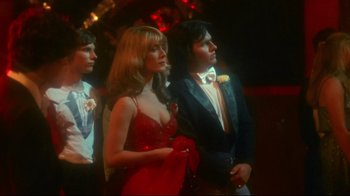 Movie still from “Prom Night” (1980), directed by Paul Lynch – A man and a woman standing next to each other in formal wear; Medium shot, Low angle