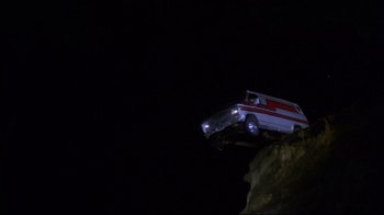 Movie still from “Prom Night” (1980), directed by Paul Lynch – An ambulance is on top of a cliff at night; Extreme Wide shot, Low angle
