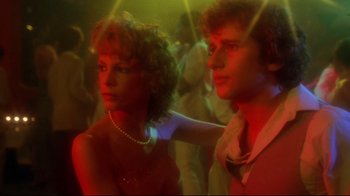 Movie still from “Prom Night” (1980), directed by Paul Lynch – A man and a woman are standing in a room; Close Up shot, Low angle
