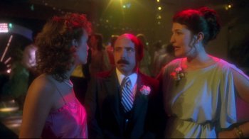 Movie still from “Prom Night” (1980), directed by Paul Lynch – A man and two women are talking to each other; Medium shot, Over the shoulder angle