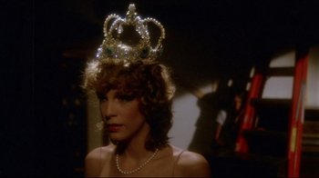 Movie still from “Prom Night” (1980), directed by Paul Lynch – A woman wearing a tiara and pearls in a room; Close Up shot, Low angle