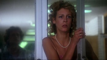 Movie still from “Prom Night” (1980), directed by Paul Lynch – A woman with a pearl necklace looking out of a window; Close Up shot, Low angle