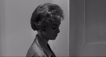 Movie still from “Psycho II” (1983), directed by Richard Franklin – A black - and - white photo of a woman with short hair; Close Up shot, Low angle