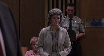 Movie still from “Psycho II” (1983), directed by Richard Franklin – An older woman standing in front of two other people; Medium shot, Over the shoulder angle