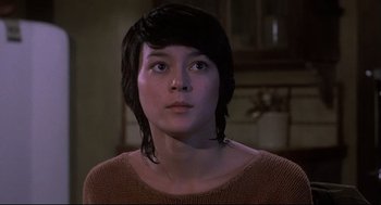 Movie still from “Psycho II” (1983), directed by Richard Franklin – A young woman with short black hair stares into the distance; Close Up shot, Low angle