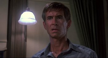Movie still from “Psycho II” (1983), directed by Richard Franklin – A person wearing a blue shirt; Close Up shot, Low angle