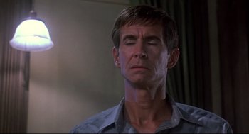 Movie still from “Psycho II” (1983), directed by Richard Franklin – A person with his eyes closed; Close Up shot, Low angle