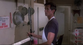 Movie still from “Psycho II” (1983), directed by Richard Franklin – A man standing in front of a kitchen sink; Close Up shot, Low angle
