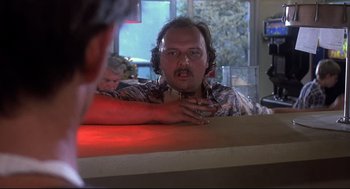 Movie still from “Psycho II” (1983), directed by Richard Franklin – A man sitting at a counter in front of a mirror; Close Up shot, Low angle