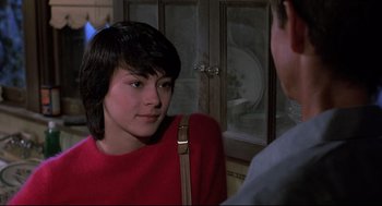 Movie still from “Psycho II” (1983), directed by Richard Franklin – A young woman wearing a red sweater talking to a young man; Close Up shot, Over the shoulder angle