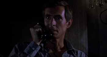 Movie still from “Psycho II” (1983), directed by Richard Franklin – A person talking on a phone; Close Up shot, Low angle