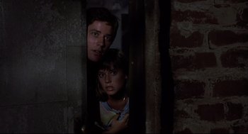 Movie still from “Psycho II” (1983), directed by Richard Franklin – A man and a woman standing next to each other; Close Up shot, Low angle