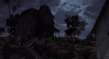 Movie still from “Psycho II” (1983), directed by Richard Franklin – A house on a hill in the night time; Extreme Wide shot, Low angle