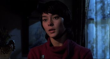 Movie still from “Psycho II” (1983), directed by Richard Franklin – A woman in a red sweater looking at the camera; Close Up shot, Low angle