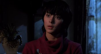 Movie still from “Psycho II” (1983), directed by Richard Franklin – A woman in a red sweater looking at the camera; Close Up shot, Low angle