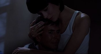 Movie still from “Psycho II” (1983), directed by Richard Franklin – A man and a woman embracing in the dark; Close Up shot, High angle