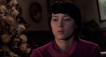 Movie still from “Psycho II” (1983), directed by Richard Franklin – A woman in a pink sweater sitting in front of a mirror; Close Up shot, Low angle