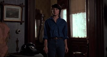 Movie still from “Psycho II” (1983), directed by Richard Franklin – A woman standing in front of a mirror in a room; Medium shot, Low angle