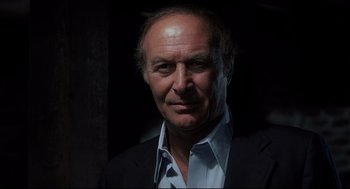 Movie still from “Psycho II” (1983), directed by Richard Franklin – An older man in a suit and tie; Close Up shot, Low angle