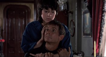 Movie still from “Psycho II” (1983), directed by Richard Franklin – A man and a woman sitting in a room; Close Up shot, Over the shoulder angle