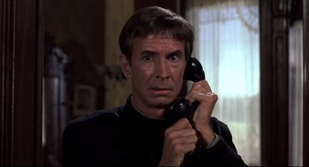 Movie still from “Psycho II” (1983), directed by Richard Franklin – A man holding a phone up to his ear; Close Up shot, Low angle