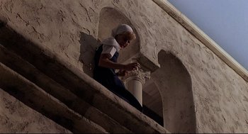 Movie still from “Psycho III” (1986), directed by Anthony Perkins – An old woman is standing on the steps of an old building; Wide shot, Low angle