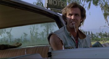 Movie still from “Psycho III” (1986), directed by Anthony Perkins – A man sitting in the drivers seat of a car while smoking a cigarette; Close Up shot, Low angle