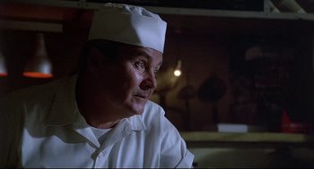 Movie still from “Psycho III” (1986), directed by Anthony Perkins – A man wearing a chef's hat looking off to his right; Close Up shot, Low angle