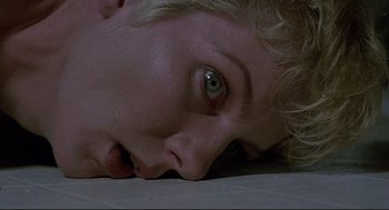 Movie still from “Psycho III” (1986), directed by Anthony Perkins – A person's face as they lay on the floor; Close Up shot, Overhead angle