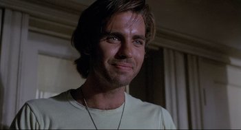 Movie still from “Psycho III” (1986), directed by Anthony Perkins – A person wearing a white shirt; Close Up shot, Low angle