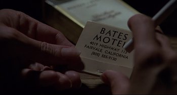 Movie still from “Psycho III” (1986), directed by Anthony Perkins – A person holding a piece of paper in front of them; Extreme Close Up shot, Overhead angle