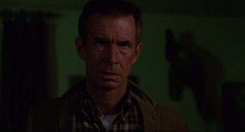 Movie still from “Psycho III” (1986), directed by Anthony Perkins – A person wearing a plaid shirt; Close Up shot, Low angle