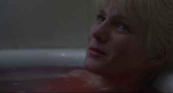 Movie still from “Psycho III” (1986), directed by Anthony Perkins – A person sitting in a bathtub; Close Up shot, High angle