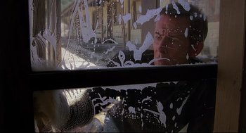 Movie still from “Psycho III” (1986), directed by Anthony Perkins – A man looking out of the window of a car; Medium shot, Low angle