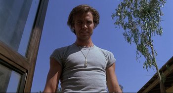 Movie still from “Psycho III” (1986), directed by Anthony Perkins – A person wearing a necklace; Close Up shot, Low angle