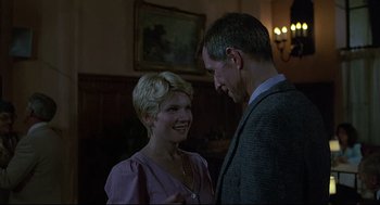 Movie still from “Psycho III” (1986), directed by Anthony Perkins – A man and a woman are talking to each other; Medium shot, Low angle