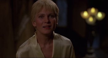 Movie still from “Psycho III” (1986), directed by Anthony Perkins – A woman with blonde hair wearing a white shirt; Close Up shot, Over the shoulder angle