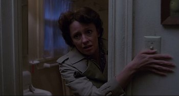 Movie still from “Psycho III” (1986), directed by Anthony Perkins – A woman leaning against a wall in a room; Close Up shot, Low angle