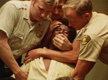 A group of police officers surrounding a man