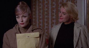 Movie still from “Puzzle of a Downfall Child” (1970), directed by Jerry Schatzberg – Two women sitting next to each other in front of a wall; Close Up shot, Over the shoulder angle