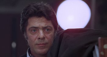 Movie still from “Puzzle of a Downfall Child” (1970), directed by Jerry Schatzberg – A person wearing a suit and tie; Close Up shot, Low angle