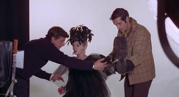Movie still from “Puzzle of a Downfall Child” (1970), directed by Jerry Schatzberg – A man and a woman being held back by another man; Medium shot, Low angle