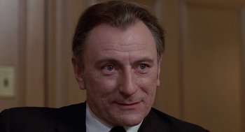 Movie still from “Puzzle of a Downfall Child” (1970), directed by Jerry Schatzberg – A person wearing a suit and tie; Close Up shot, Low angle