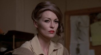 Movie still from “Puzzle of a Downfall Child” (1970), directed by Jerry Schatzberg – A person wearing a dress shirt; Close Up shot, Over the shoulder angle