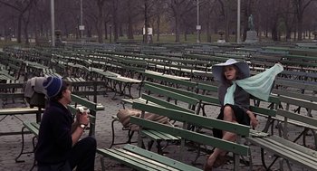 Movie still from “Puzzle of a Downfall Child” (1970), directed by Jerry Schatzberg – Two women sitting on green park benches in a park; Wide shot, High angle