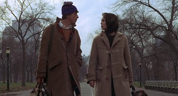 Movie still from “Puzzle of a Downfall Child” (1970), directed by Jerry Schatzberg – A man and a woman holding hands while walking down a street; Medium shot, Low angle