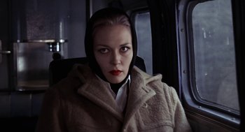 Movie still from “Puzzle of a Downfall Child” (1970), directed by Jerry Schatzberg – A woman in a hooded coat sitting in a car; Close Up shot, Low angle