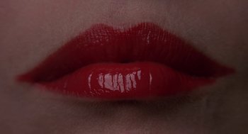 Movie still from “Puzzle of a Downfall Child” (1970), directed by Jerry Schatzberg – View of a woman's red lips; Extreme Close Up shot, Overhead angle