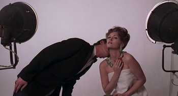 Movie still from “Puzzle of a Downfall Child” (1970), directed by Jerry Schatzberg – A man and a woman in a white dress and a black suit; Close Up shot, Low angle